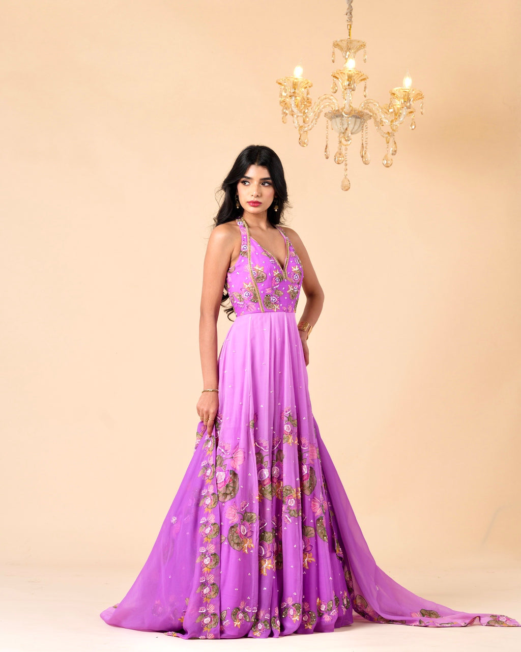 Woman wearing a purple floral dress against a beige background