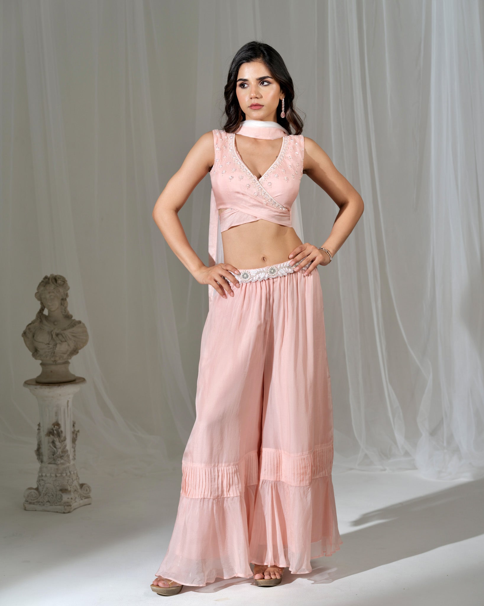 Woman wearing a pink traditional outfit with a white background