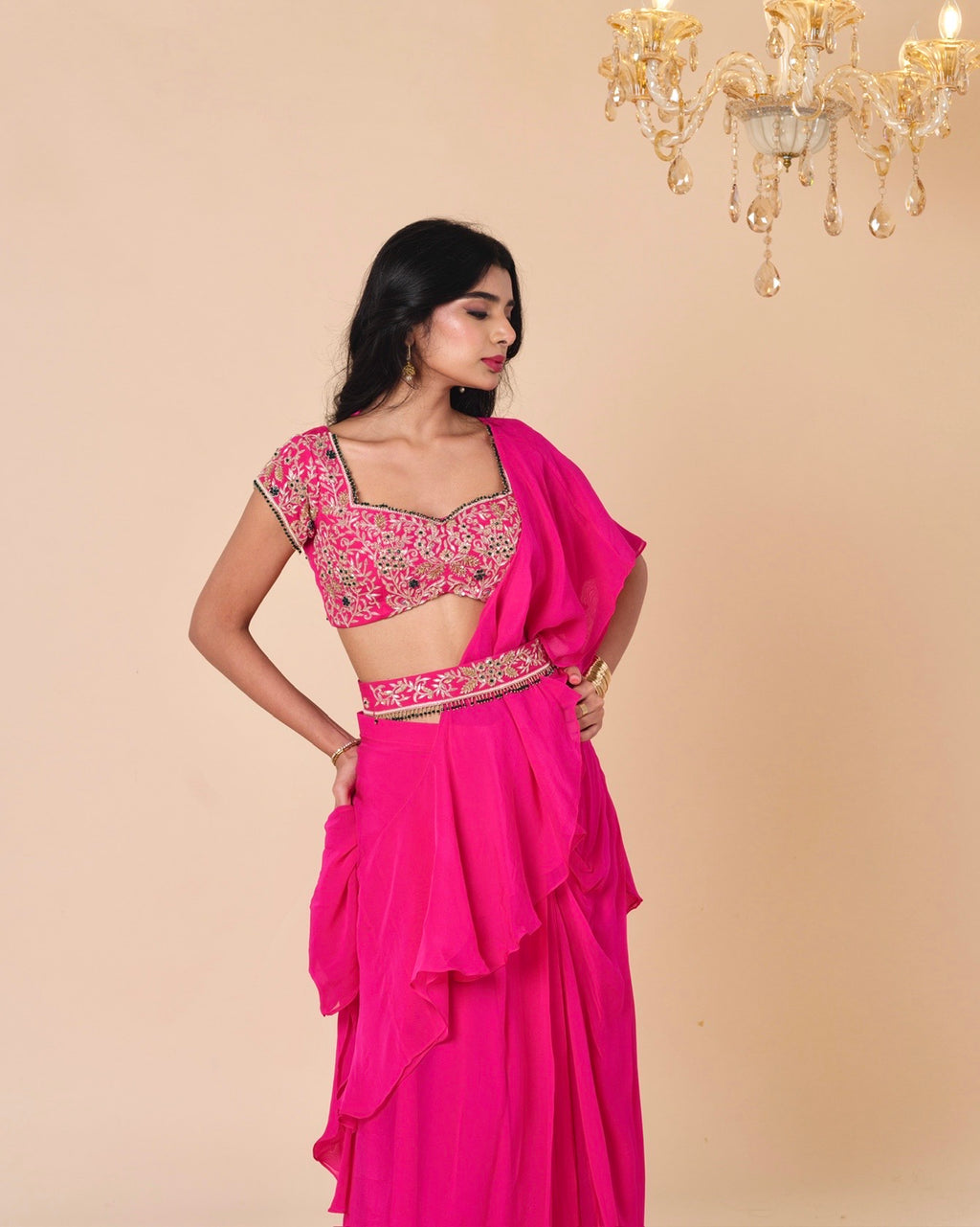 Woman wearing a pink traditional outfit with a beige background