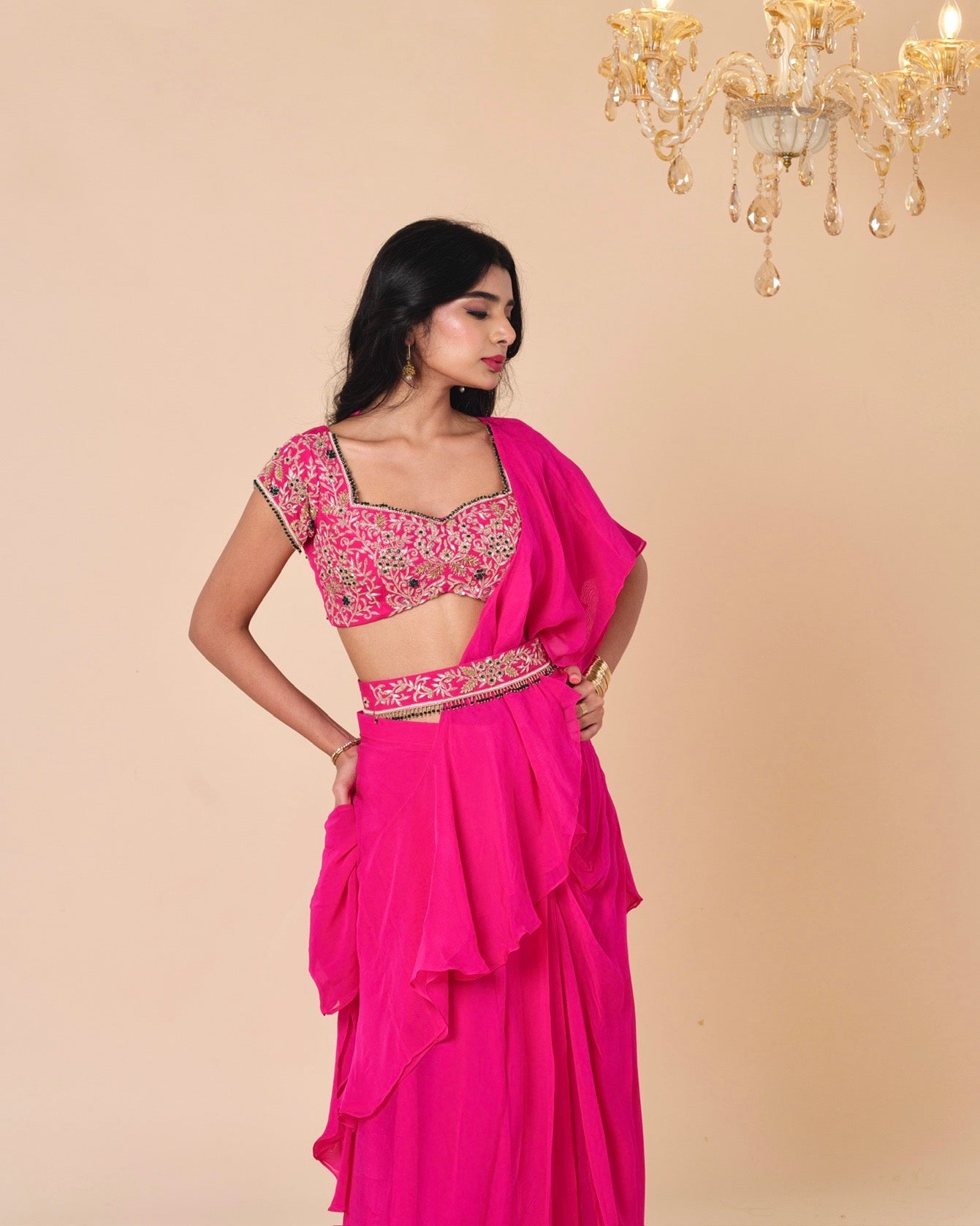 Woman wearing a pink traditional outfit with a beige background