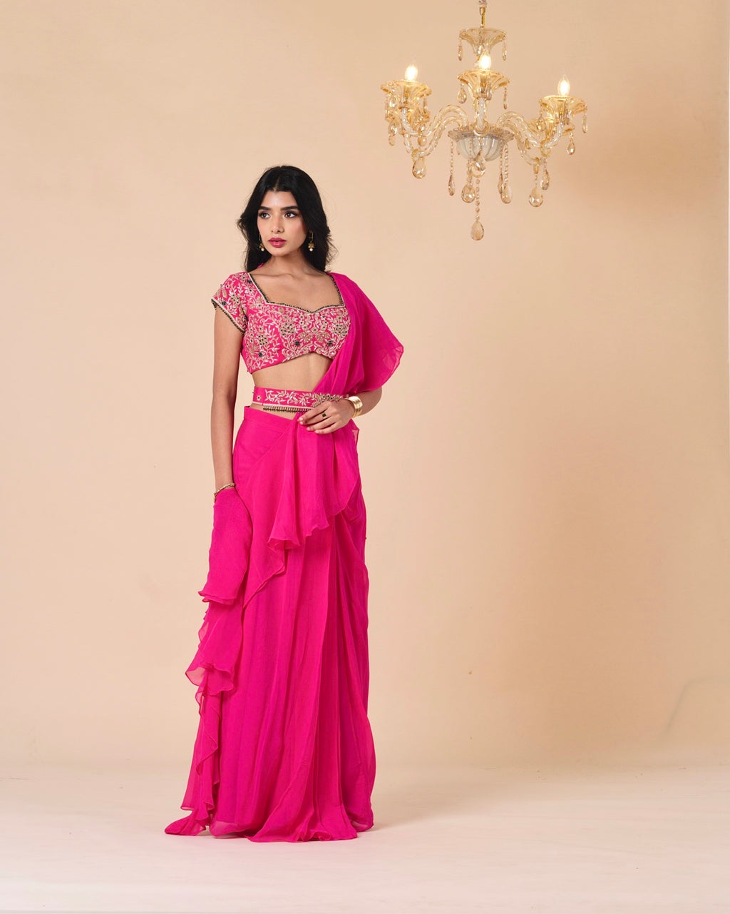 Woman wearing a pink traditional outfit with a beige background