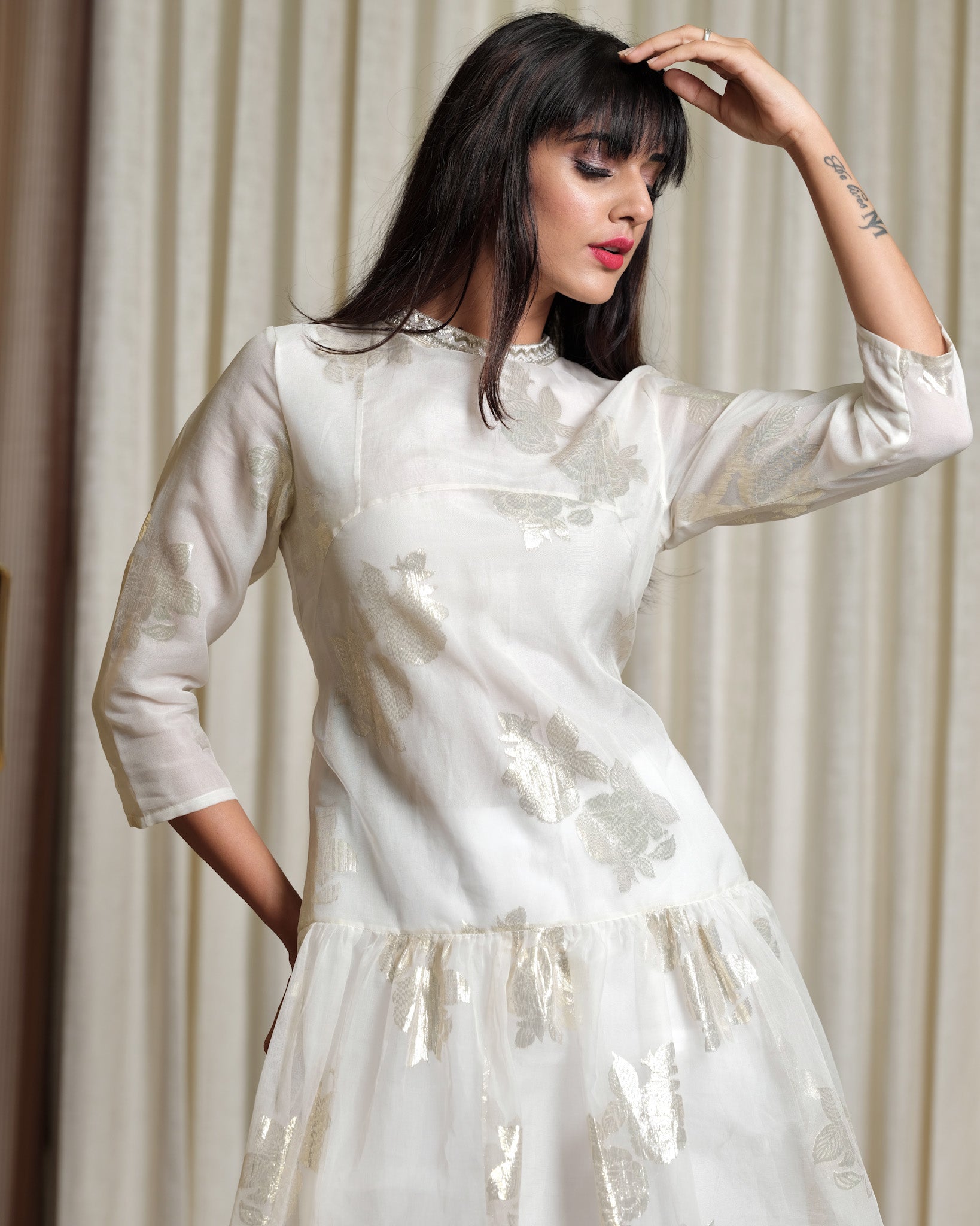 Woman wearing a white dress with a plain background