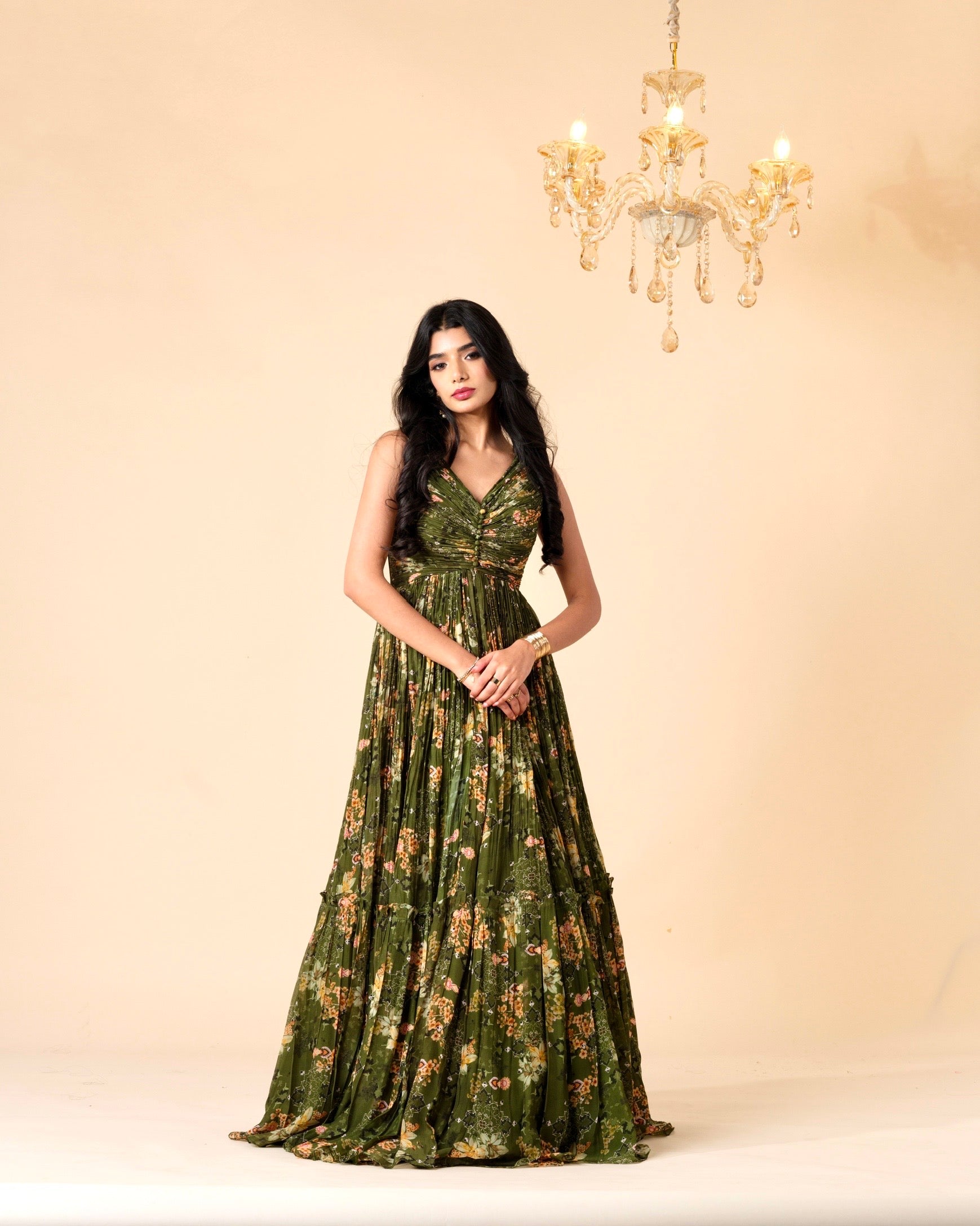 Woman wearing a green floral dress against a beige background